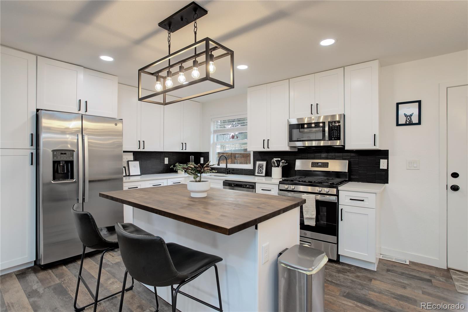 95 Fitzsimmons Road Bailey, CO 80421 - Photo 9 of 38 a kitchen with stainless steel appliances a stove refrigerator sink and microwave
