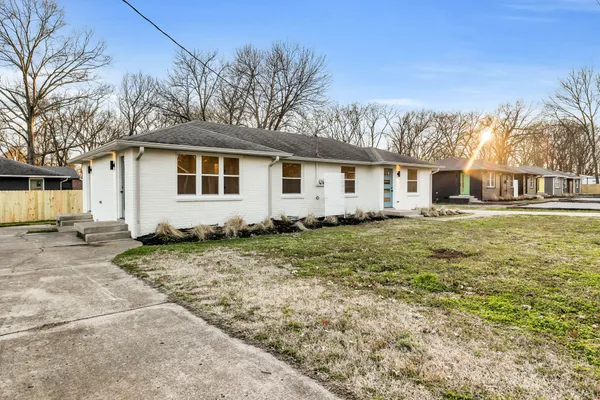 a view of a yard with a house and a tree