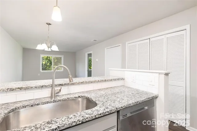 a kitchen with granite countertop a sink and a window
