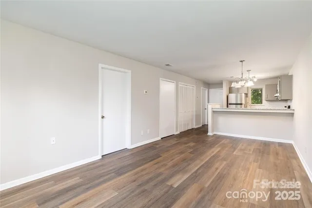 a view of a kitchen with wooden floor and kitchen space