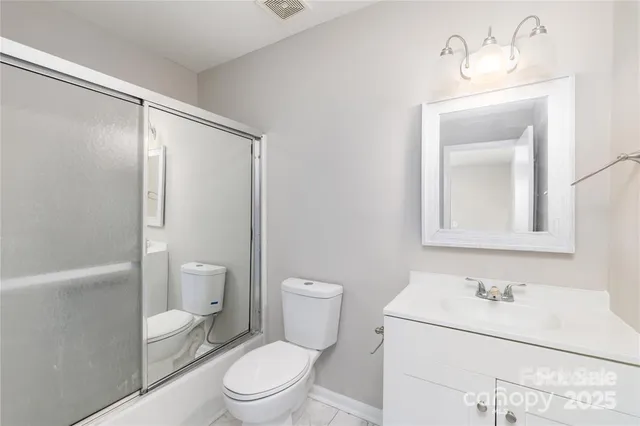 a bathroom with a toilet a sink and a mirror