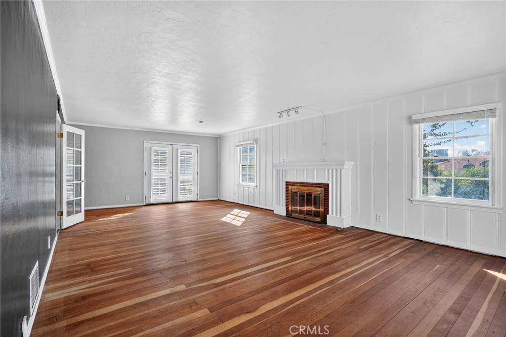 1717 Locust Ravine Bakersfield, CA 93306 - Photo 12 of 29 wooden floor fireplace and windows in an empty room