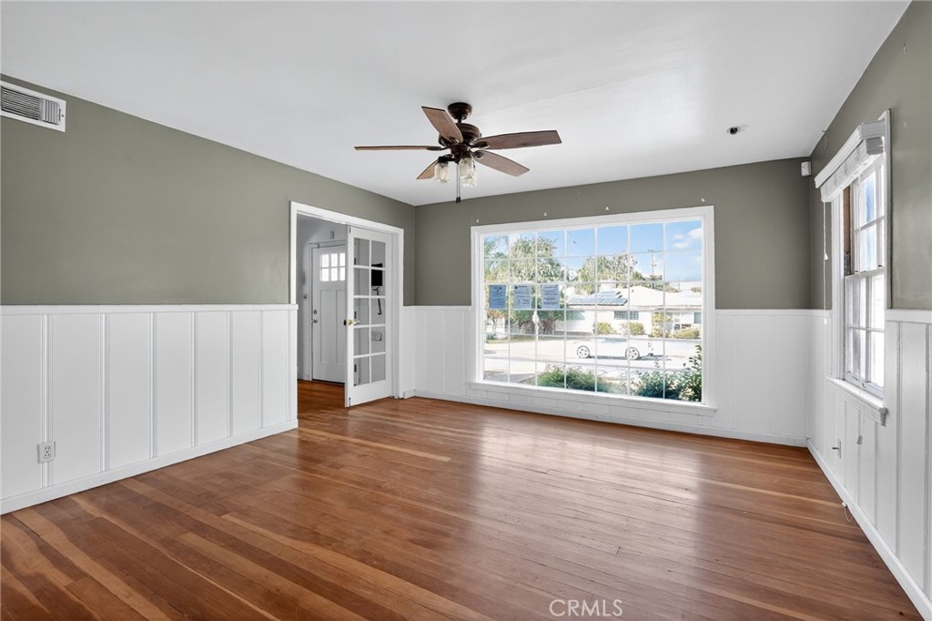 1717 Locust Ravine Bakersfield, CA 93306 - Photo 13 of 29 a view of a livingroom with wooden floor a ceiling fan and windows