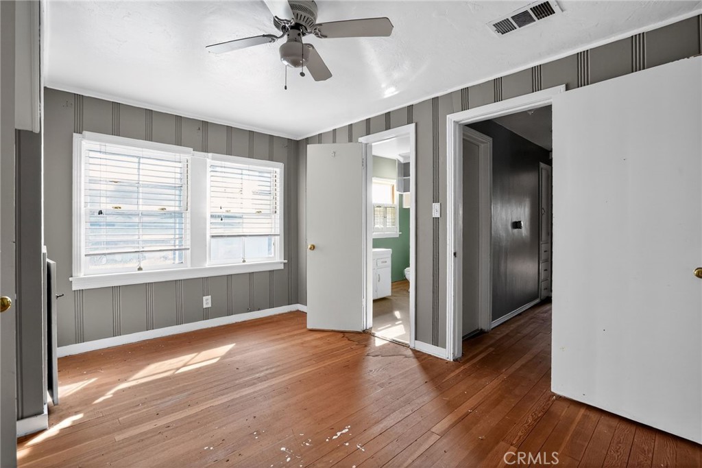 1717 Locust Ravine Bakersfield, CA 93306 - Photo 14 of 29 a view of an empty room with a window and wooden floor