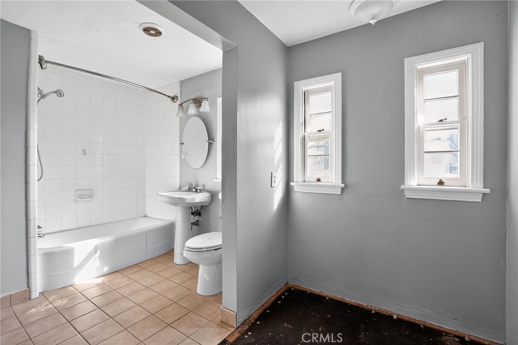 1717 Locust Ravine Bakersfield, CA 93306 - Photo 18 of 29 a bathroom with a toilet tub and a shower