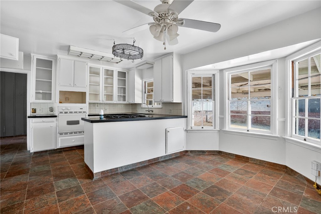 1717 Locust Ravine Bakersfield, CA 93306 - Photo 6 of 29 a kitchen with stainless steel appliances granite countertop a stove a sink and a refrigerator