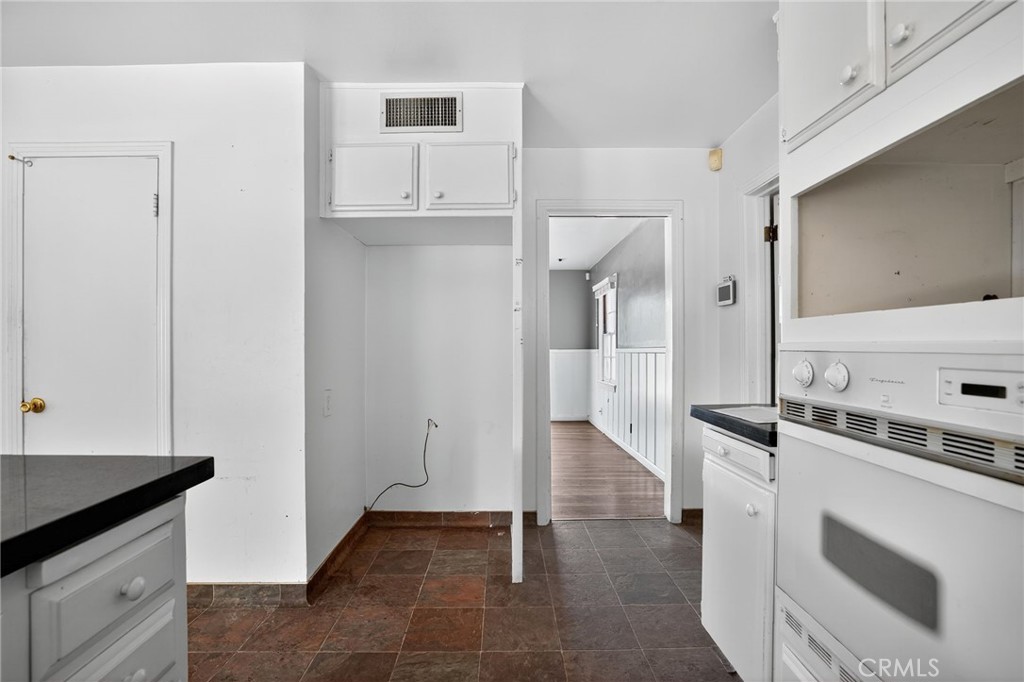 1717 Locust Ravine Bakersfield, CA 93306 - Photo 7 of 29 a kitchen with granite countertop a sink and a stove top oven