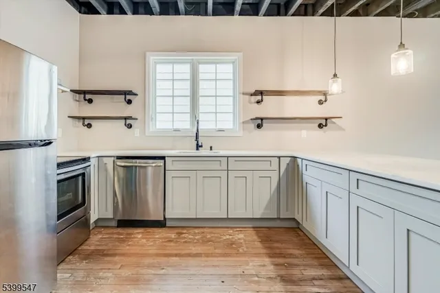 a kitchen with white cabinets and white appliances