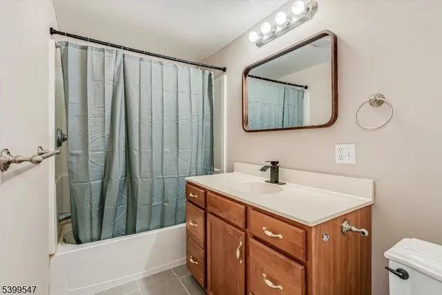 a bathroom with a sink vanity and a mirror