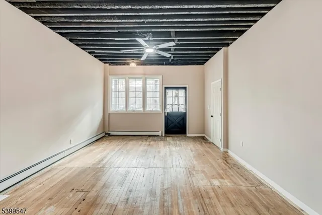 a view of wooden floor and windows in an empty room