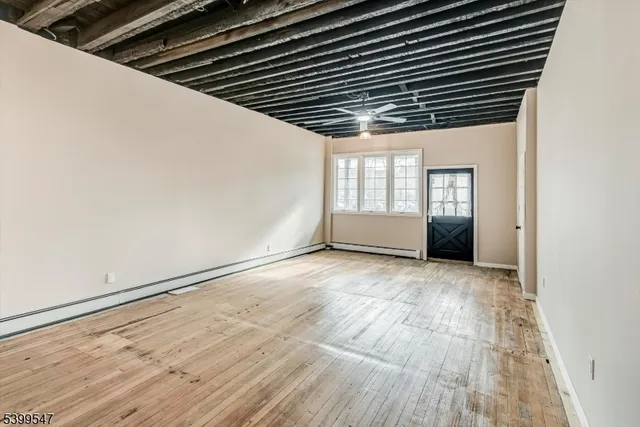 a view of wooden floor and windows in an empty room