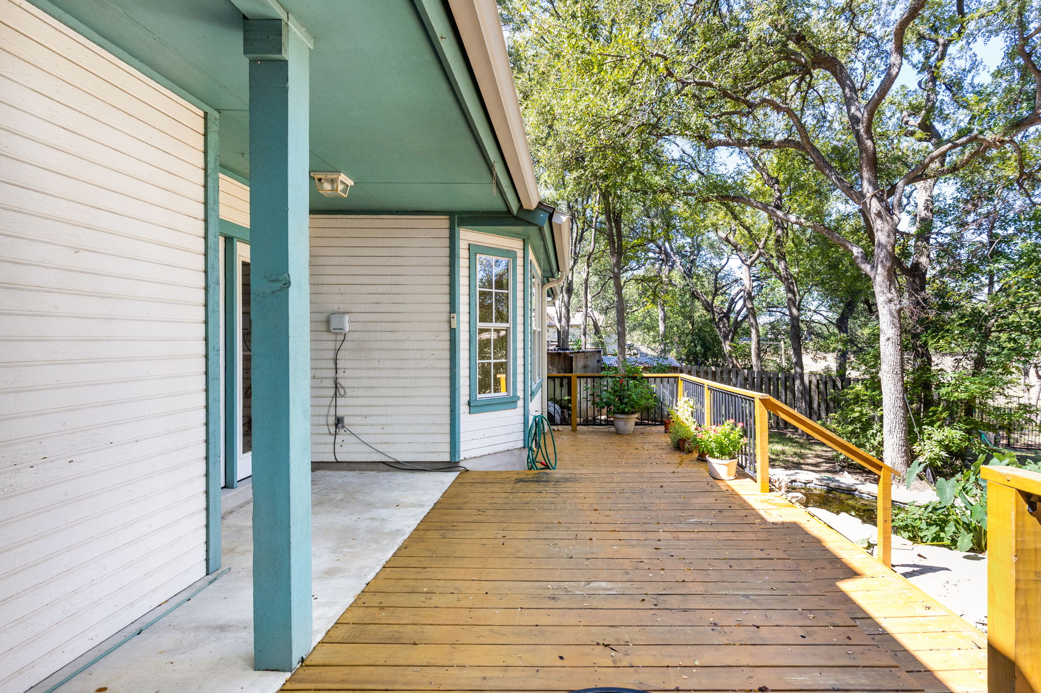 134 Canyon Road Georgetown, TX 78628 - Photo 24 of 40 Mature trees frame the spacious outdoor deck, ideal for enjoying peaceful wooded views.