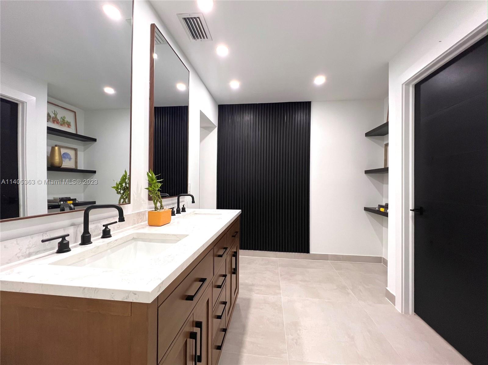 1201 Northwest 3rd Avenue Boca Raton, FL 33432 - Photo 13 of 29 a bathroom with a sink a toilet and a mirror
