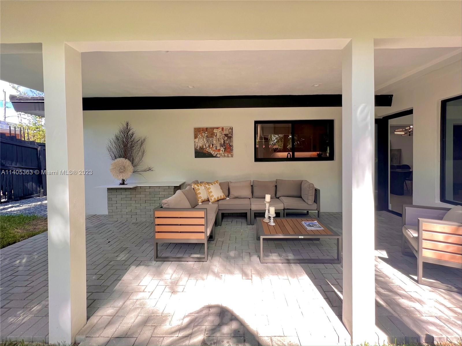 1201 Northwest 3rd Avenue Boca Raton, FL 33432 - Photo 28 of 29 a living room with furniture and a flat screen tv