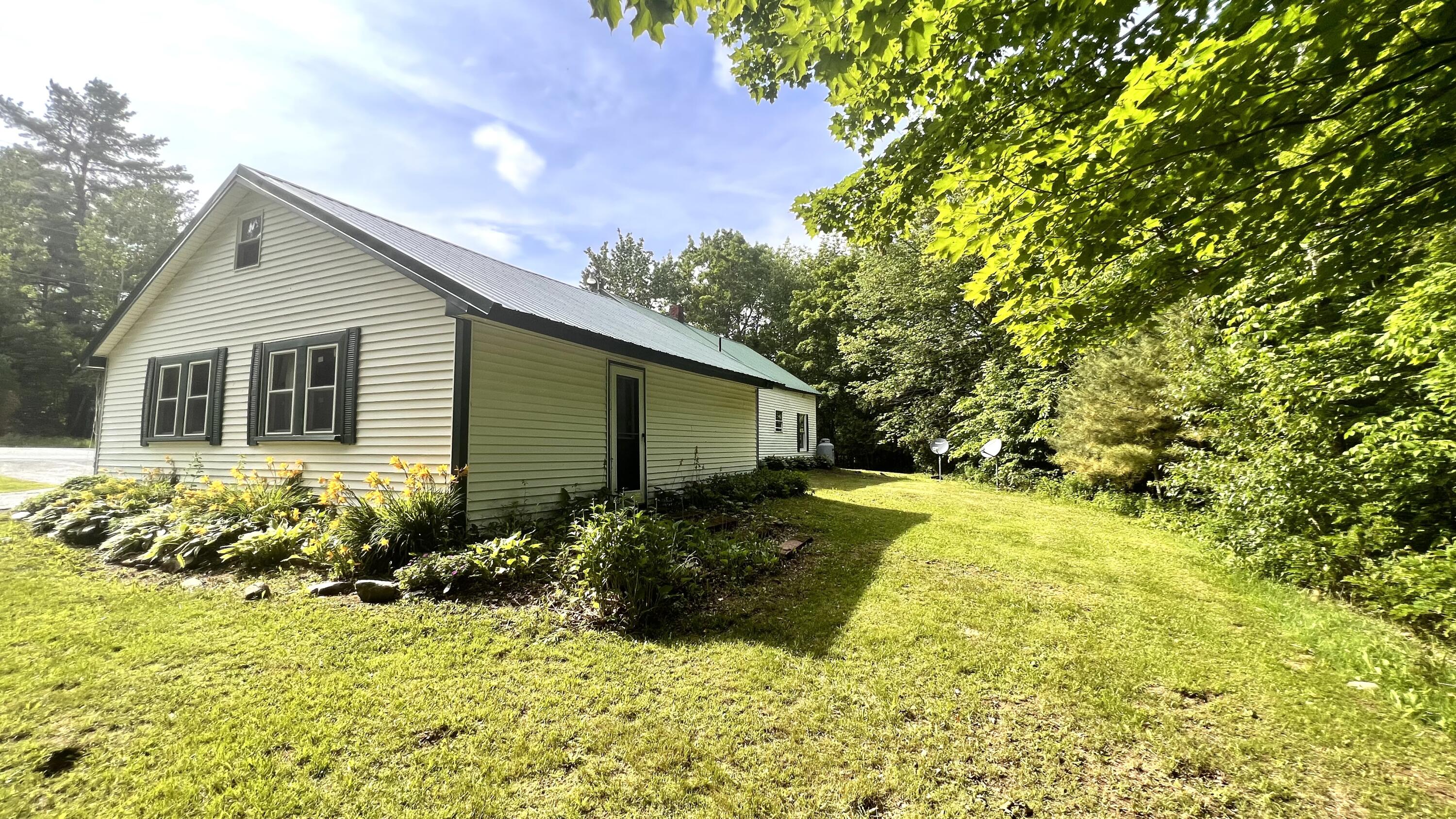 801 Stetson Road Exeter, ME 04435 - Photo 11 of 53 11. Back of garage and back lawn