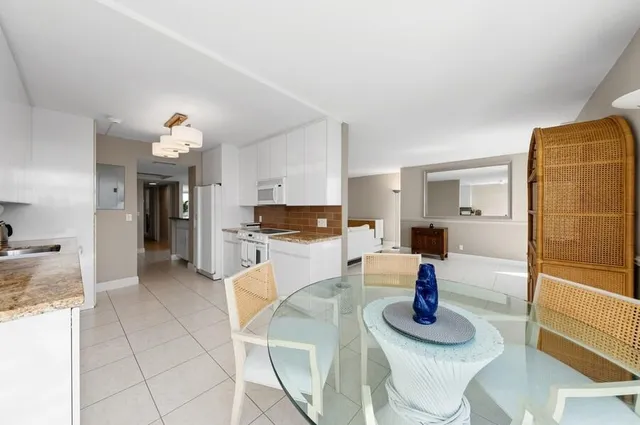 a open kitchen with dining table and chairs