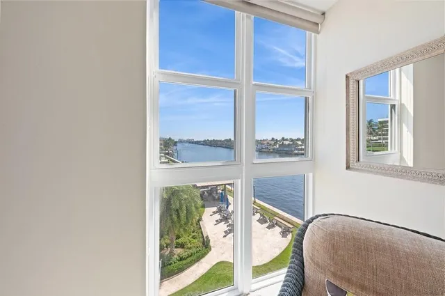 a bathroom with a granite countertop sink a toilet and a mirror