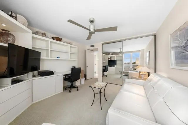 a spacious bathroom with a sink and mirror with toilet