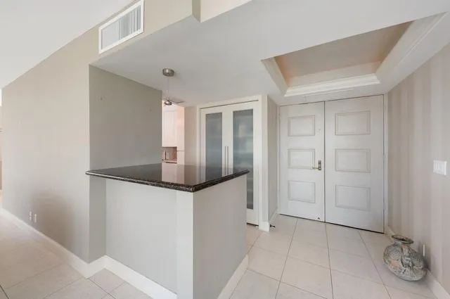 a bathroom with a glass shower door and a window