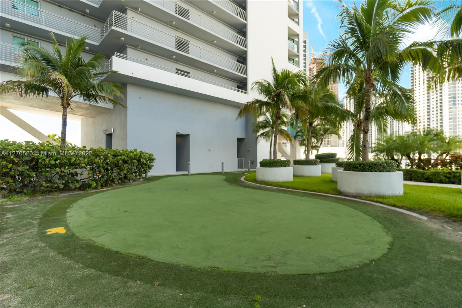 888 Biscayne Boulevard, Unit 3301 Miami, FL 33132 - Photo 17 of 29 a view of a house with a backyard and a patio