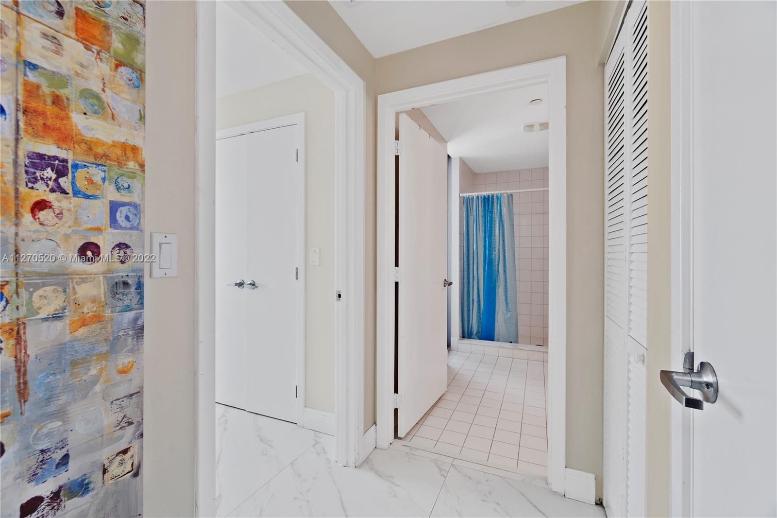 888 Biscayne Boulevard, Unit 3301 Miami, FL 33132 - Photo 28 of 29 a view of a hallway with windows and closet