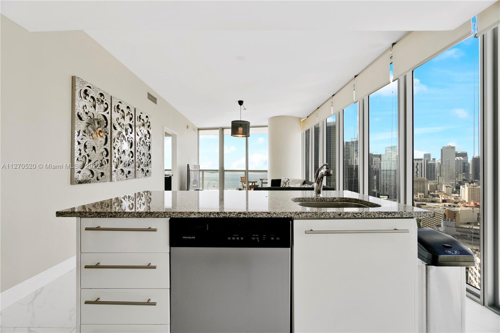 888 Biscayne Boulevard, Unit 3301 Miami, FL 33132 - Photo 3 of 29 a kitchen with a sink and cabinets