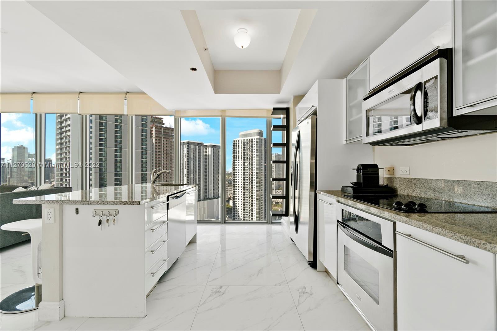 888 Biscayne Boulevard, Unit 3301 Miami, FL 33132 - Photo 4 of 29 a kitchen with stainless steel appliances granite countertop a stove and a sink