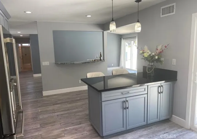 a kitchen with cabinets and window
