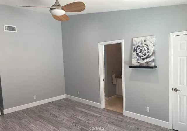 an empty room with wooden floor