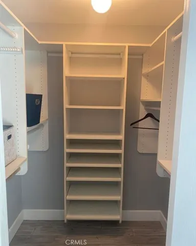 a view of walk in closet with empty racks