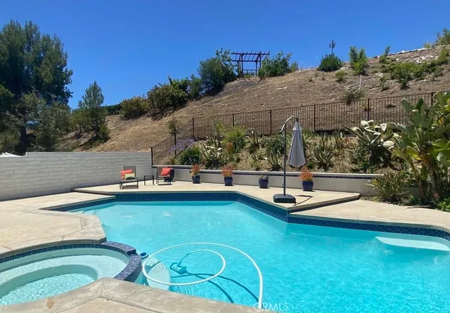 a view of swimming pool with lounge chair