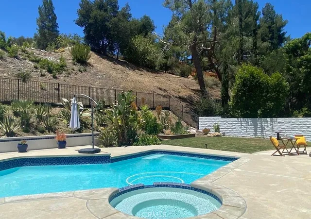 a front view of house with yard outdoor seating and barbeque oven