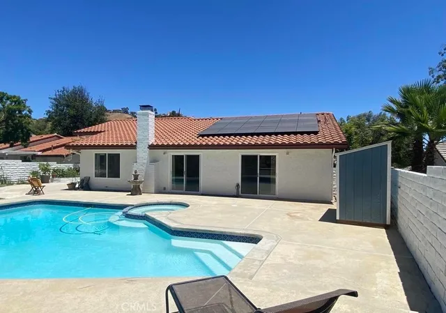 a backyard of a house with table and chairs