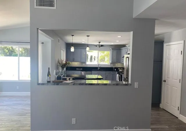a view of a living room with kitchen island furniture and a wooden floor