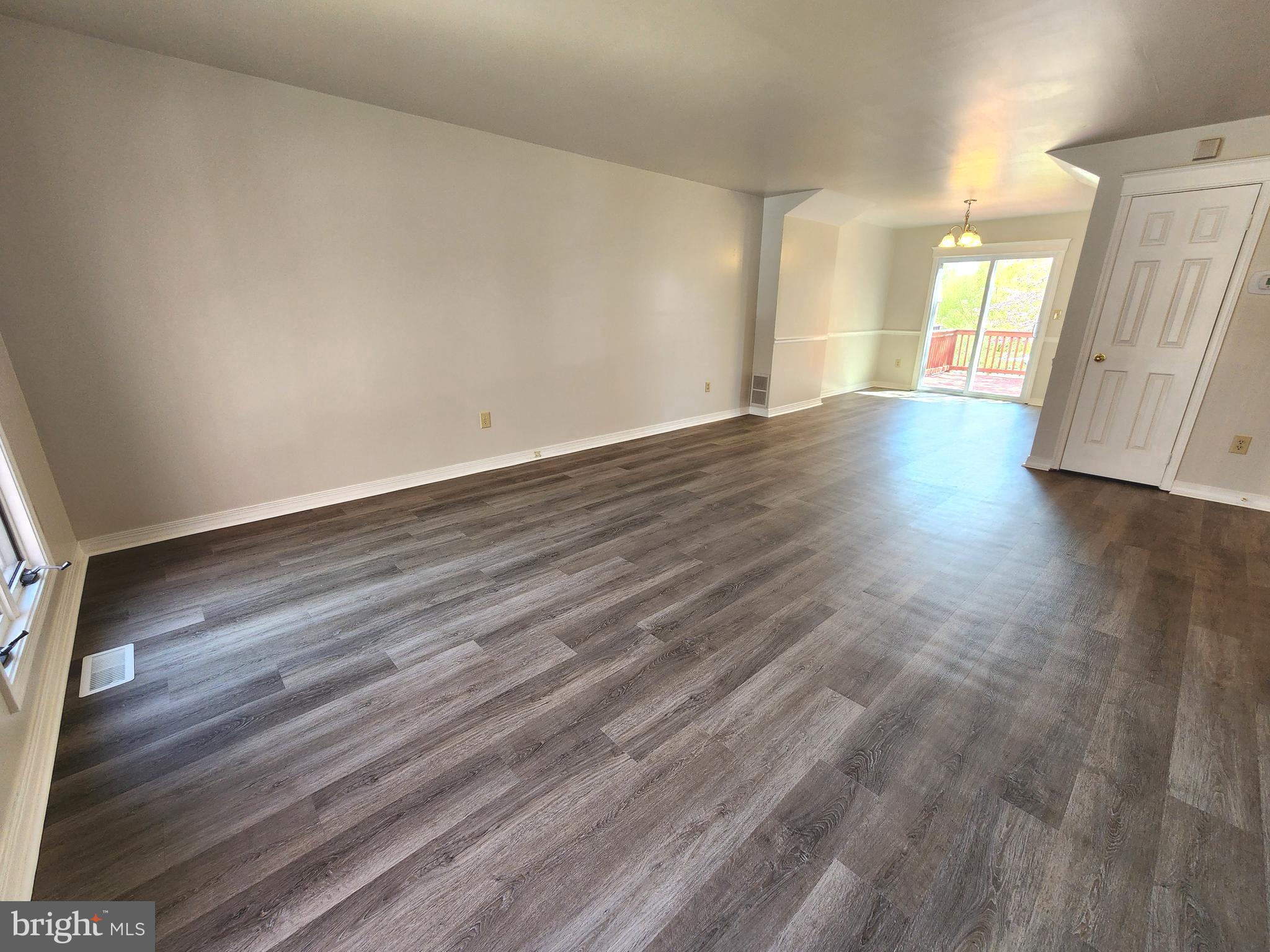 655 Knightsbridge Drive Hagerstown, MD 21740 - Photo 6 of 32 a view of an empty room with wooden floor and a window