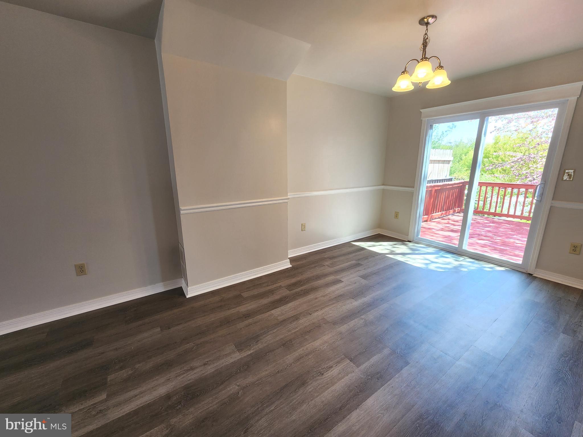 655 Knightsbridge Drive Hagerstown, MD 21740 - Photo 7 of 32 an empty room with wooden floor and windows