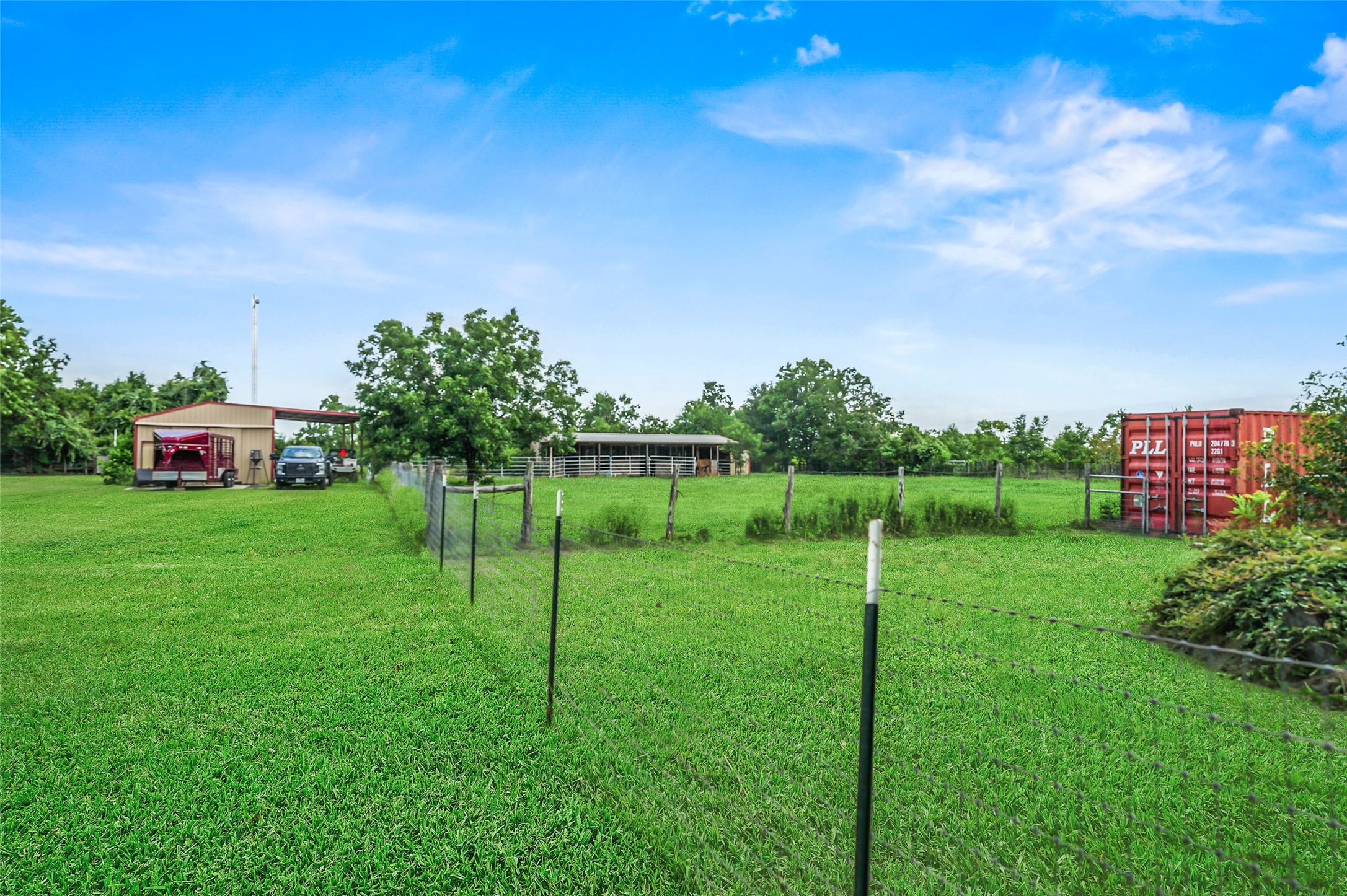 34366 Owens Road Hempstead, TX 77445 - Photo 43 of 46 expansive fenced backyard with lush green lawn, mature trees, and open space for gardening, recreation, pets, or future outdoor amenities.