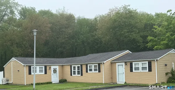 a aerial view of a house next to a yard