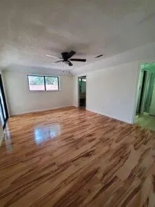 a view of empty room with wooden floor