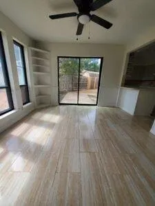 a large kitchen with cabinets and wooden floor