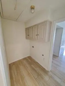 a kitchen with stainless steel appliances cabinets a sink and a wooden floor