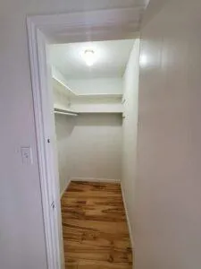 a view of a livingroom with wooden floor and a fireplace