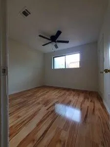 a view of a livingroom with a ceiling fan and window