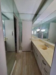 a view of a bathroom with tub sink and mirror