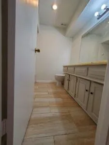 a view of a room with wooden floor and a sink