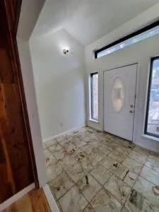 a view of empty room with wooden floor and fireplace