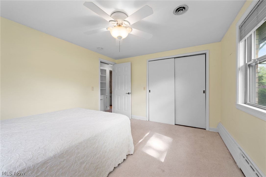 8106 Middlesex Road Mentor, OH 44060 - Photo 19 of 32 Bedroom with a closet, ceiling fan, carpet, and baseboard heating