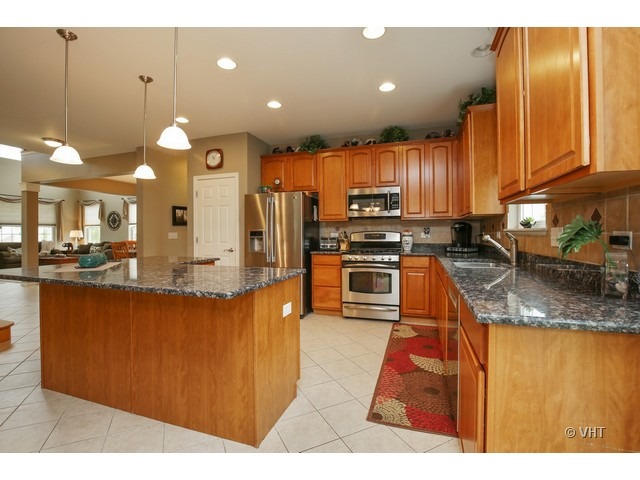 3038 Range Road Elgin, IL 60124 - Photo 4 of 10 a kitchen with stainless steel appliances granite countertop a sink a stove and a refrigerator