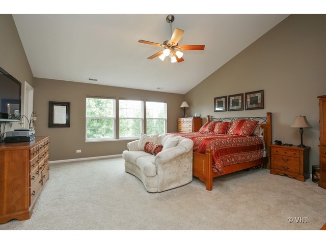 3038 Range Road Elgin, IL 60124 - Photo 8 of 10 a bedroom with a bed and a chandelier