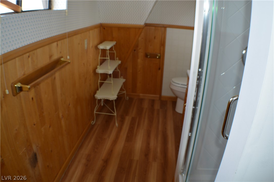 1321 Trout Canyon Road Las Vegas, NV 89124 - Photo 42 of 50 Wood-paneled walls and a sleek walk-in shower create a clean and functional bathing area.